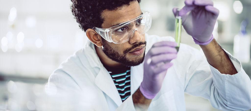 Man looking at chemical in lab