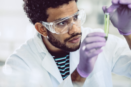 Man looking at chemical in lab