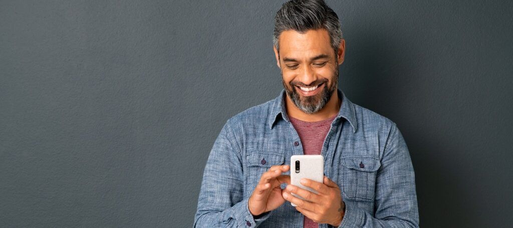 Man using social media smiling