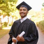 Smiling student graduating wearing cap and gown