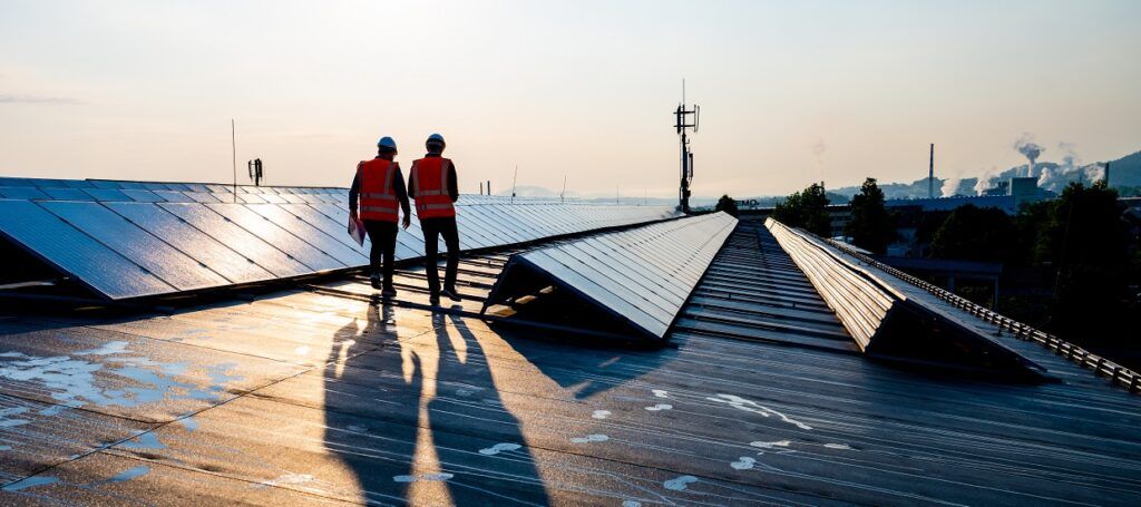 Two engineers working with solar panels